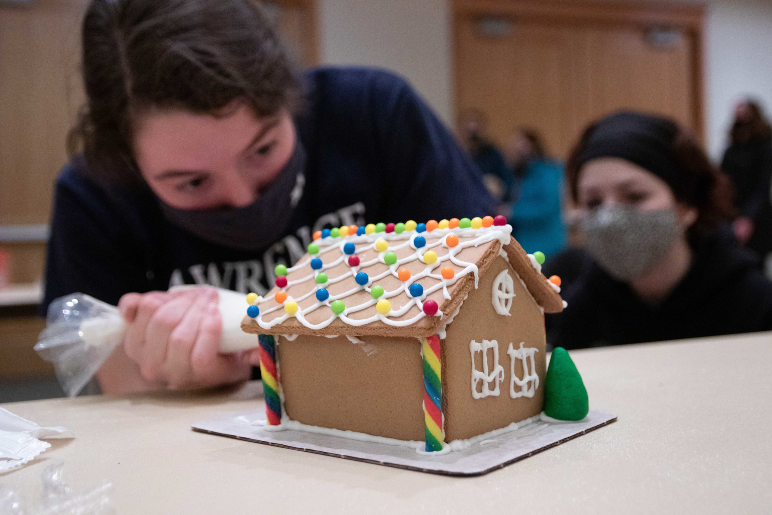 Masked student doctorates gingerbread house