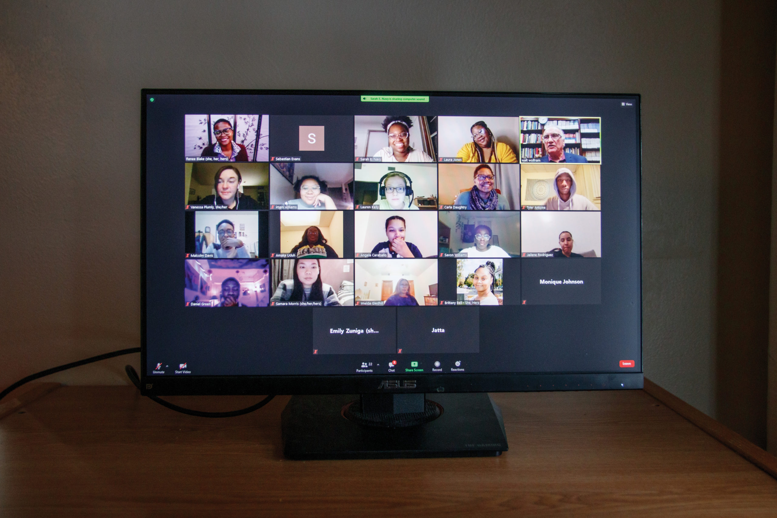 Computer screen with zoom screen displaying students and staff.